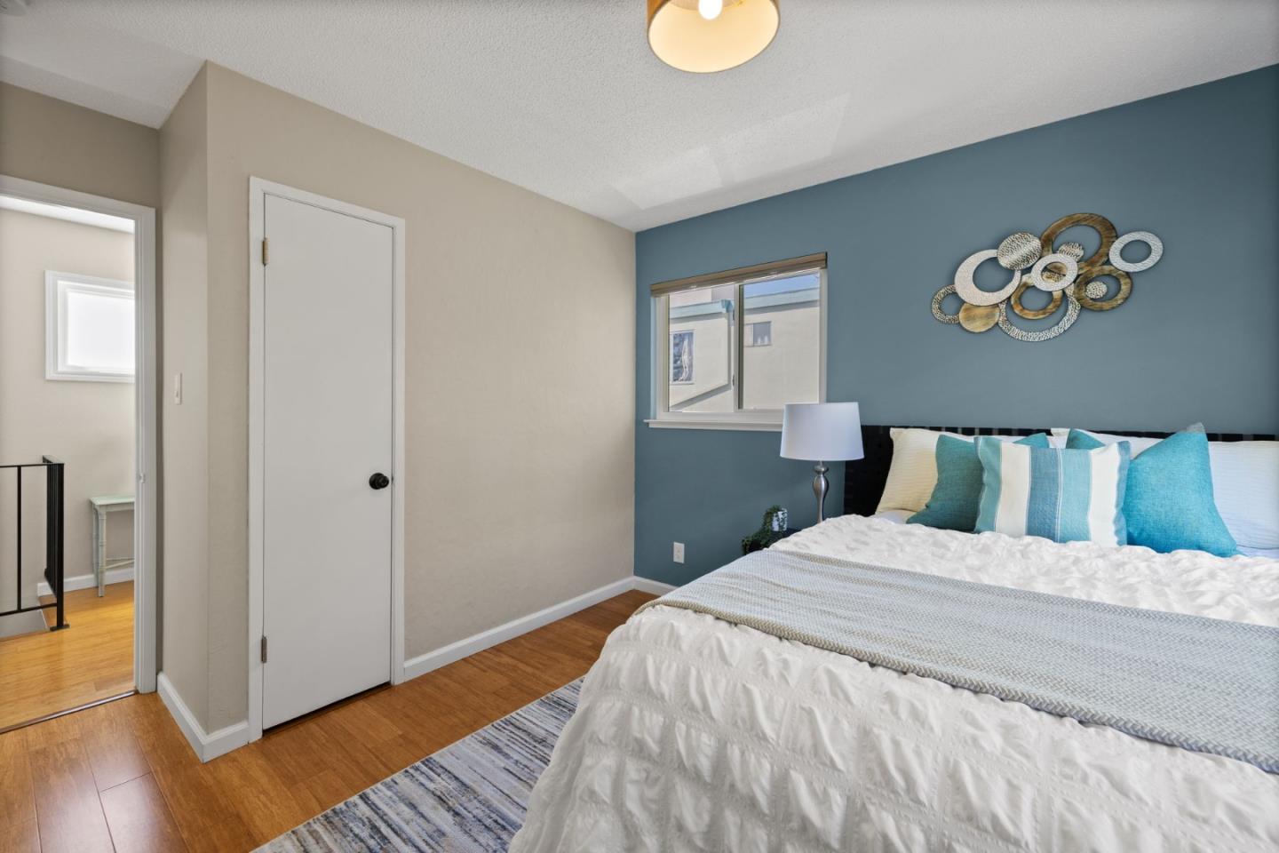 1337 Henry Street, Unit E Berkeley, CA 94709 - Photo 16 of 33 a bedroom with a large bed and a chandelier