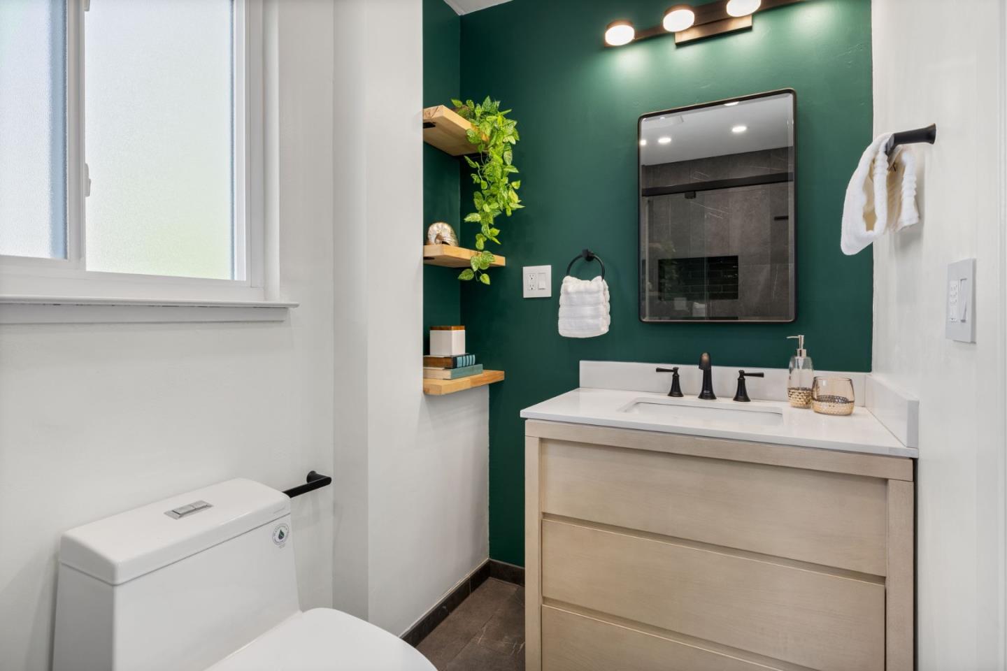 1337 Henry Street, Unit E Berkeley, CA 94709 - Photo 19 of 33 a bathroom with a toilet sink and mirror
