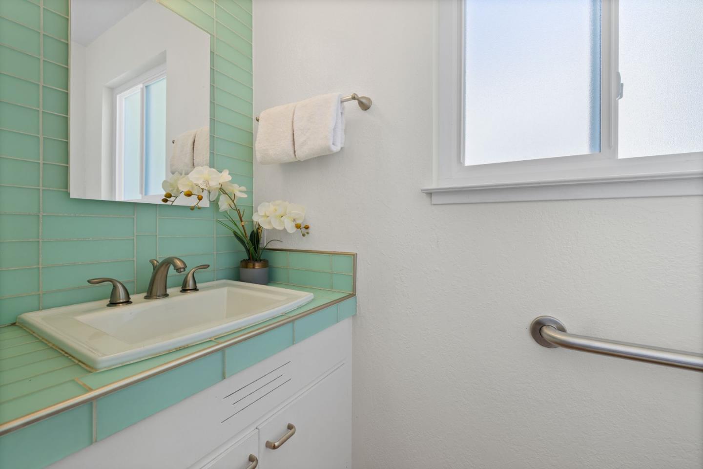 1337 Henry Street, Unit E Berkeley, CA 94709 - Photo 21 of 33 a bathroom with a sink and a mirror