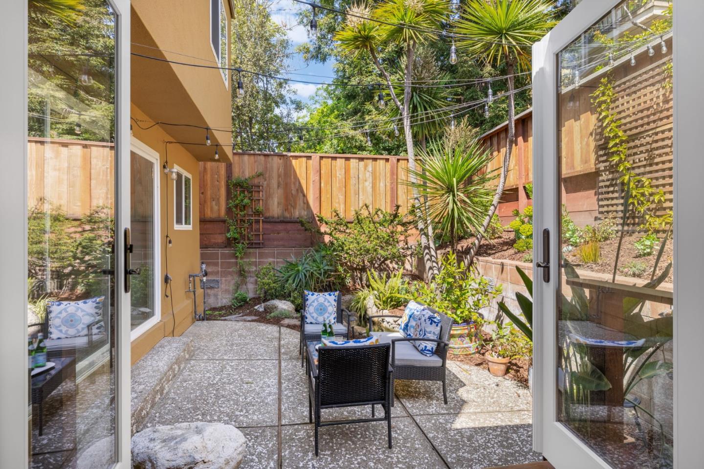 1337 Henry Street, Unit E Berkeley, CA 94709 - Photo 24 of 33 a view of a patio with table and chairs potted plants