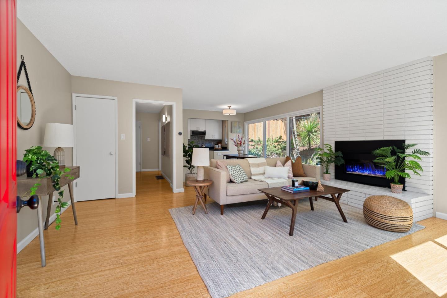 1337 Henry Street, Unit E Berkeley, CA 94709 - Photo 6 of 33 a living room with furniture flat screen tv and a fireplace