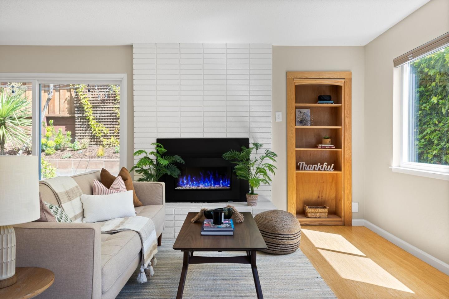 1337 Henry Street, Unit E Berkeley, CA 94709 - Photo 8 of 33 a living room with furniture a window and a fireplace
