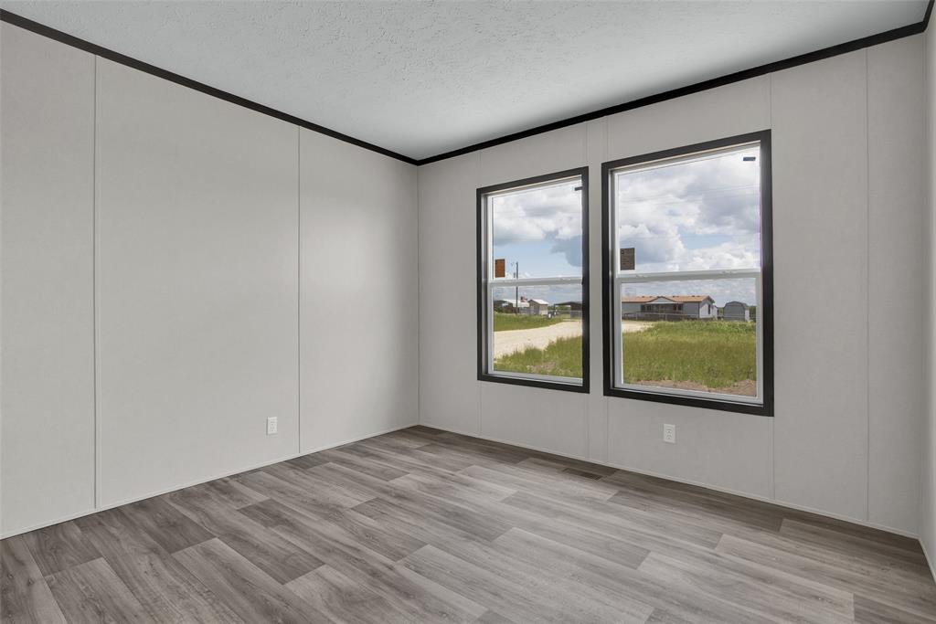 1203 Old Ida Road Sherman, TX 75090 - Photo 20 of 20 an empty room with wooden floor and windows