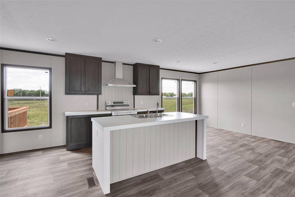 1203 Old Ida Road Sherman, TX 75090 - Photo 9 of 20 a kitchen with stainless steel appliances a stove a sink and a refrigerator