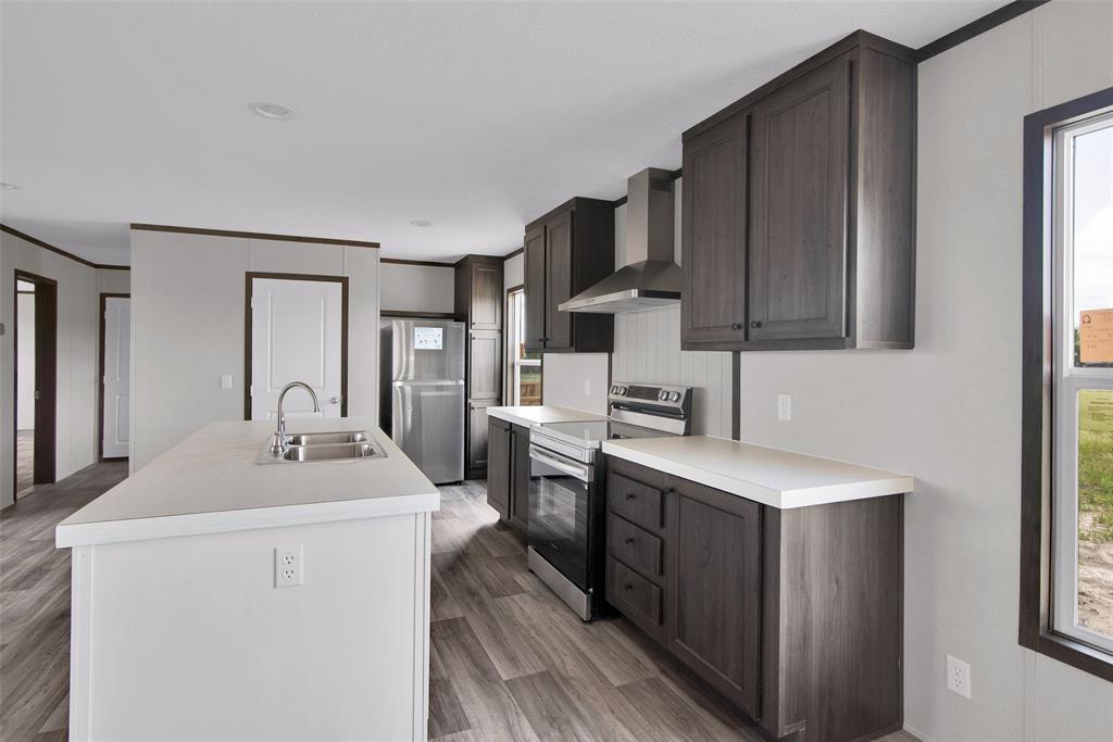 1203 Old Ida Road Sherman, TX 75090 - Photo 10 of 20 a kitchen that has a sink a stove and chairs