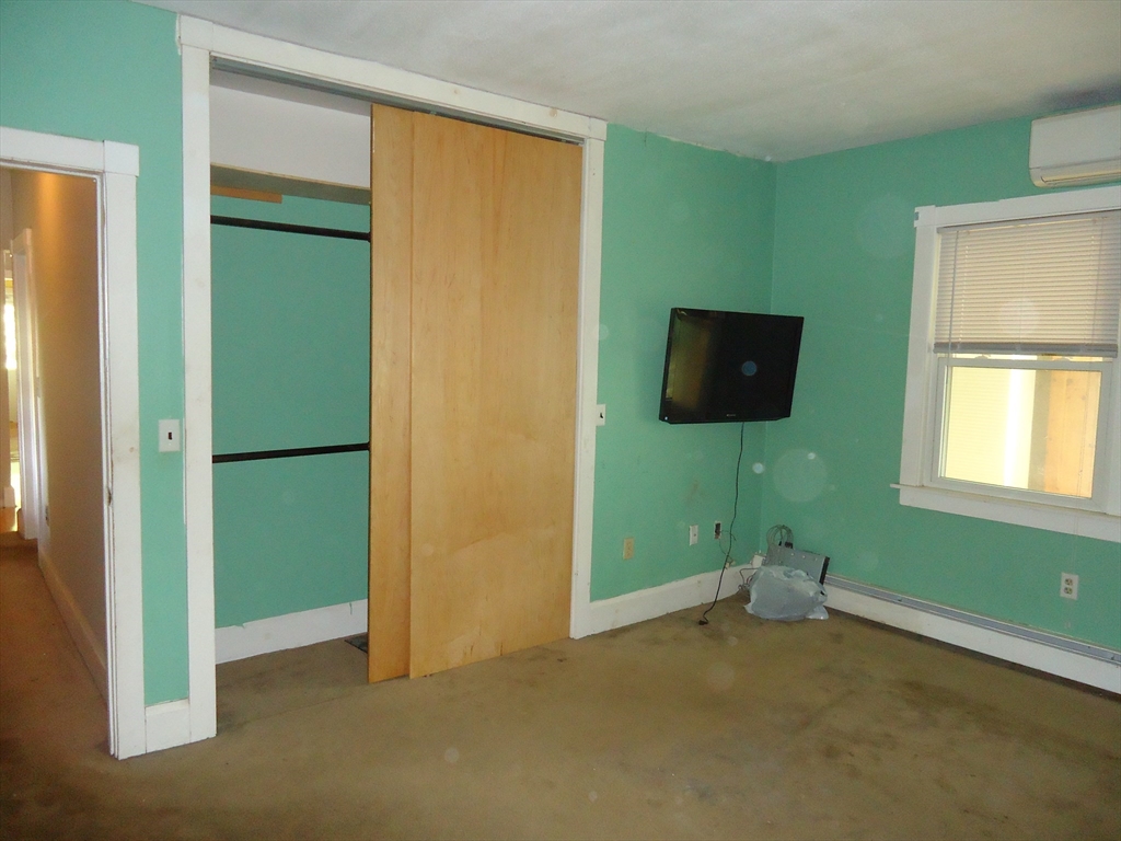 361 River Road Hudson, MA 01749 - Photo 14 of 37 a living room with a flat screen tv and a window