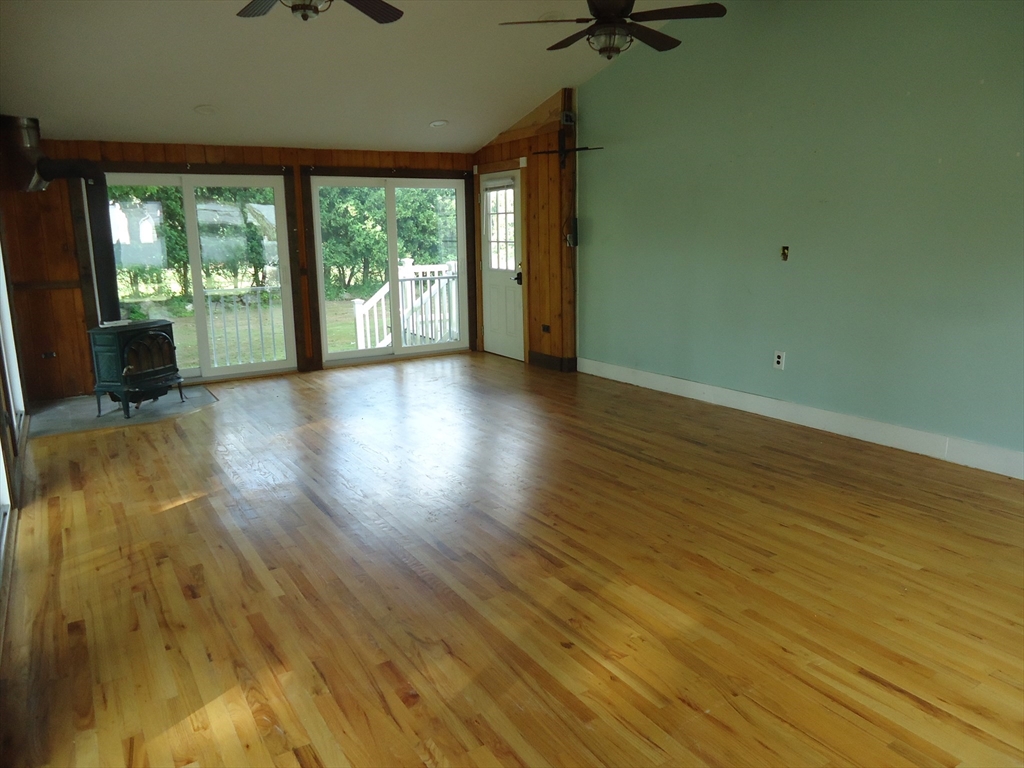 361 River Road Hudson, MA 01749 - Photo 16 of 37 an empty room with wooden floor and windows