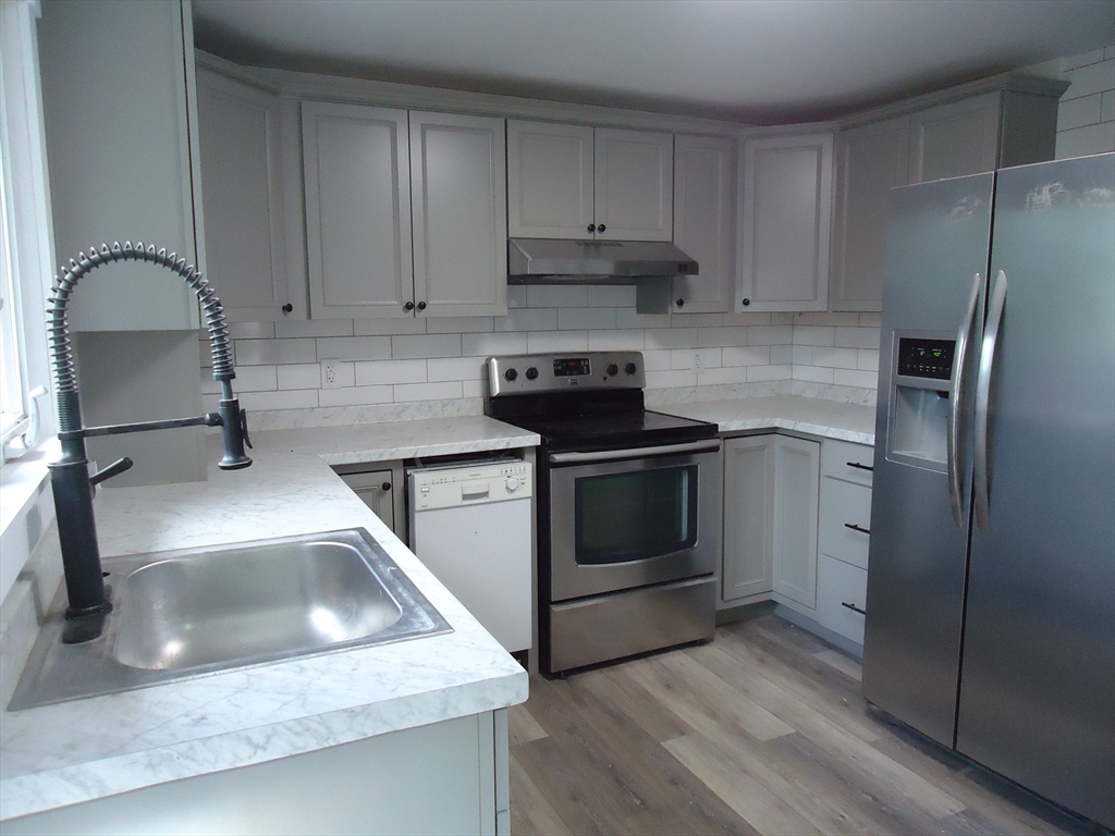 361 River Road Hudson, MA 01749 - Photo 18 of 37 a kitchen with a sink stove and refrigerator