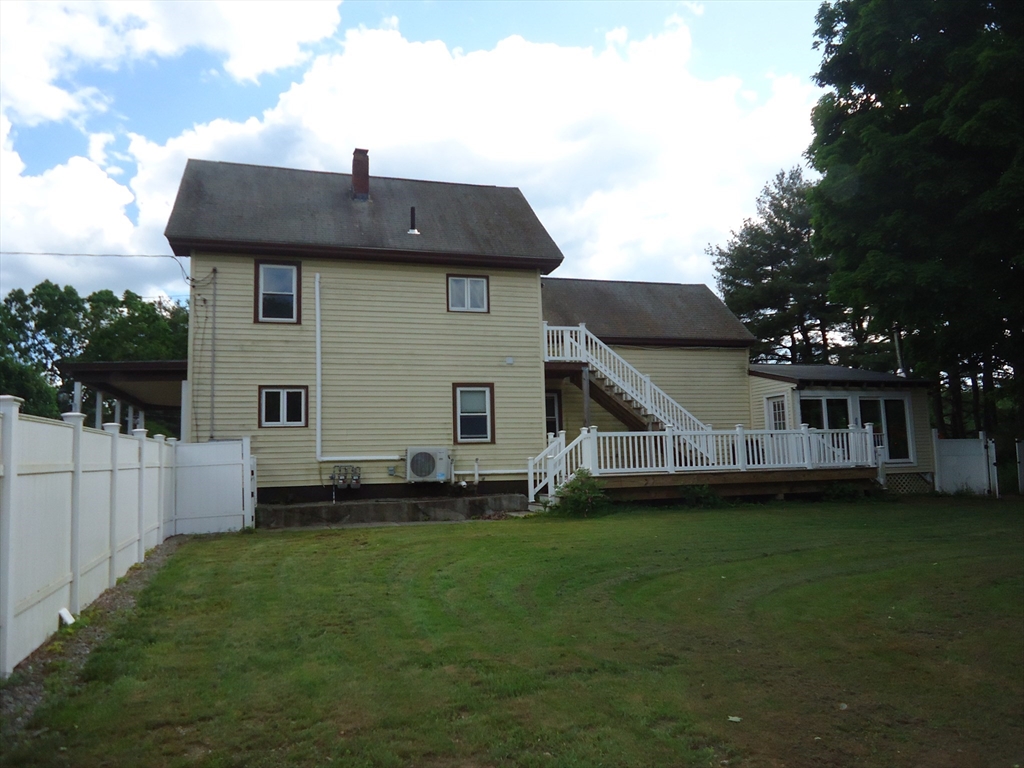 361 River Road Hudson, MA 01749 - Photo 2 of 37 a front view of a house with a garden