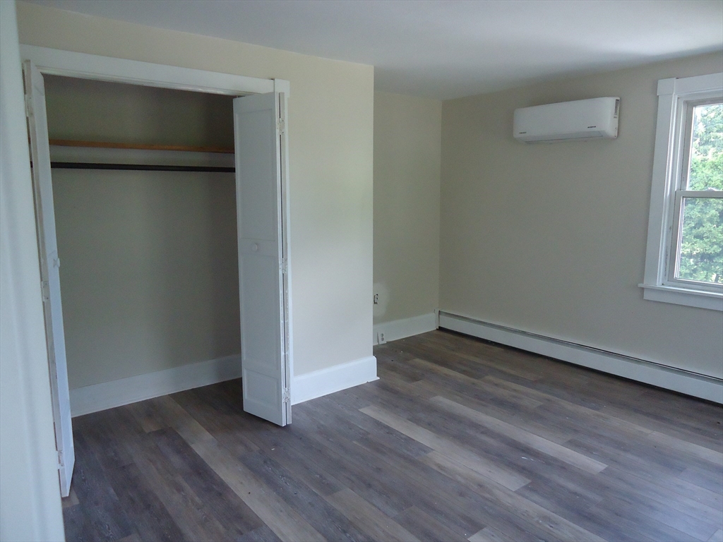 361 River Road Hudson, MA 01749 - Photo 27 of 37 an empty room with wooden floor and windows