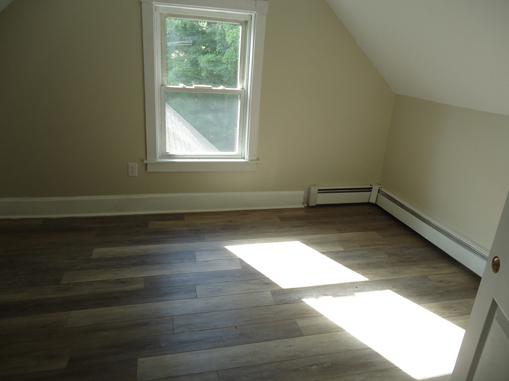 361 River Road Hudson, MA 01749 - Photo 33 of 37 an empty room with wooden floor and windows