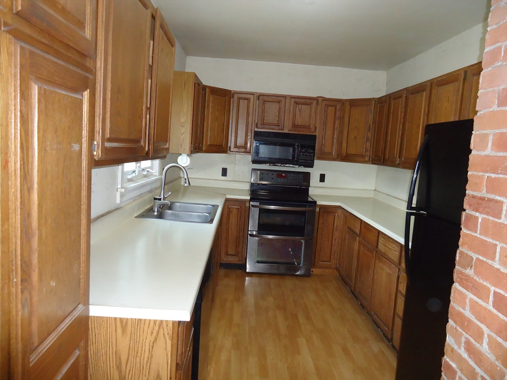 361 River Road Hudson, MA 01749 - Photo 6 of 37 a kitchen with a sink a stove top oven a refrigerator and dishwasher