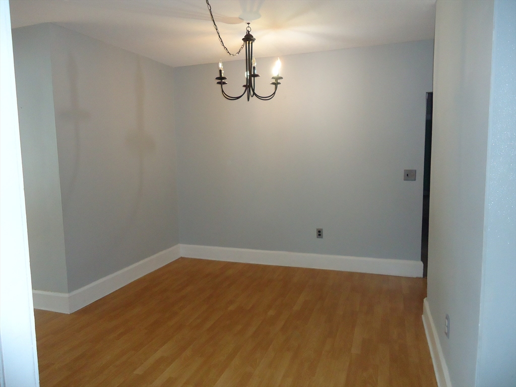 361 River Road Hudson, MA 01749 - Photo 8 of 37 a view of a small space with wooden floor and a window