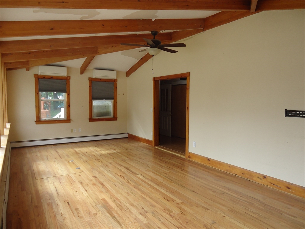 361 River Road Hudson, MA 01749 - Photo 9 of 37 a view of an empty room with wooden floor and windows