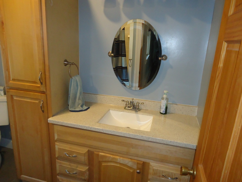 361 River Road Hudson, MA 01749 - Photo 10 of 37 a bathroom with a sink and a mirror
