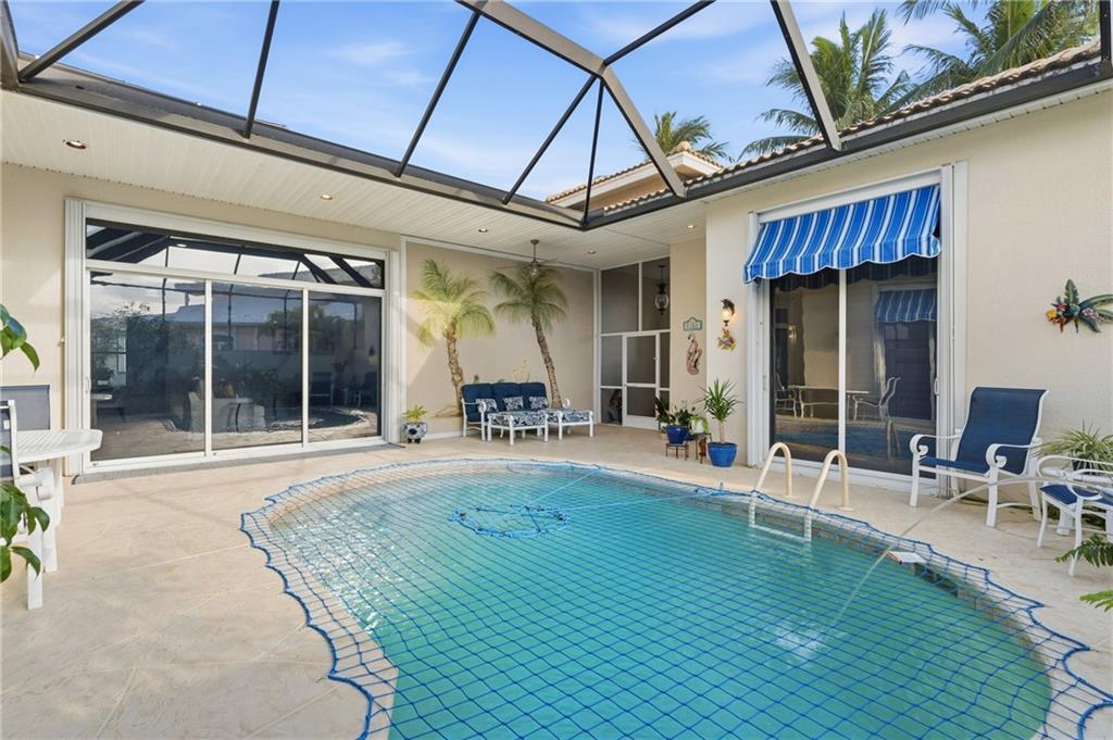 1344 Riverside Lane Vero Beach, FL 32963 - Photo 13 of 36 a swimming pool with table and chairs