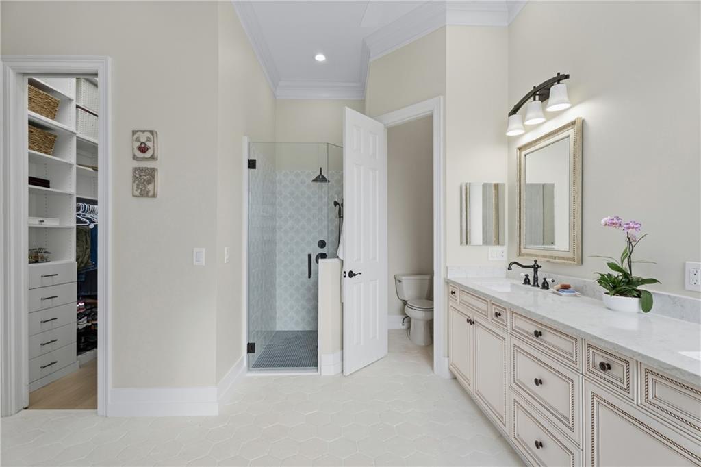 1344 Riverside Lane Vero Beach, FL 32963 - Photo 15 of 36 a spacious bathroom with a double vanity sink a large mirror and a shower