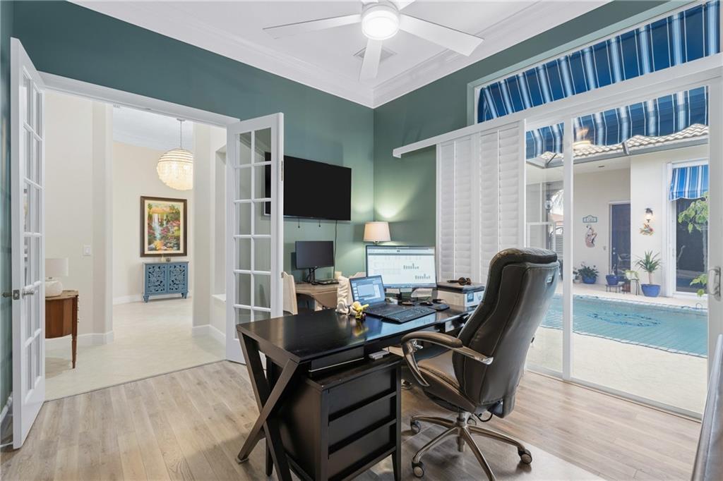 1344 Riverside Lane Vero Beach, FL 32963 - Photo 16 of 36 a work room with furniture and wooden floor