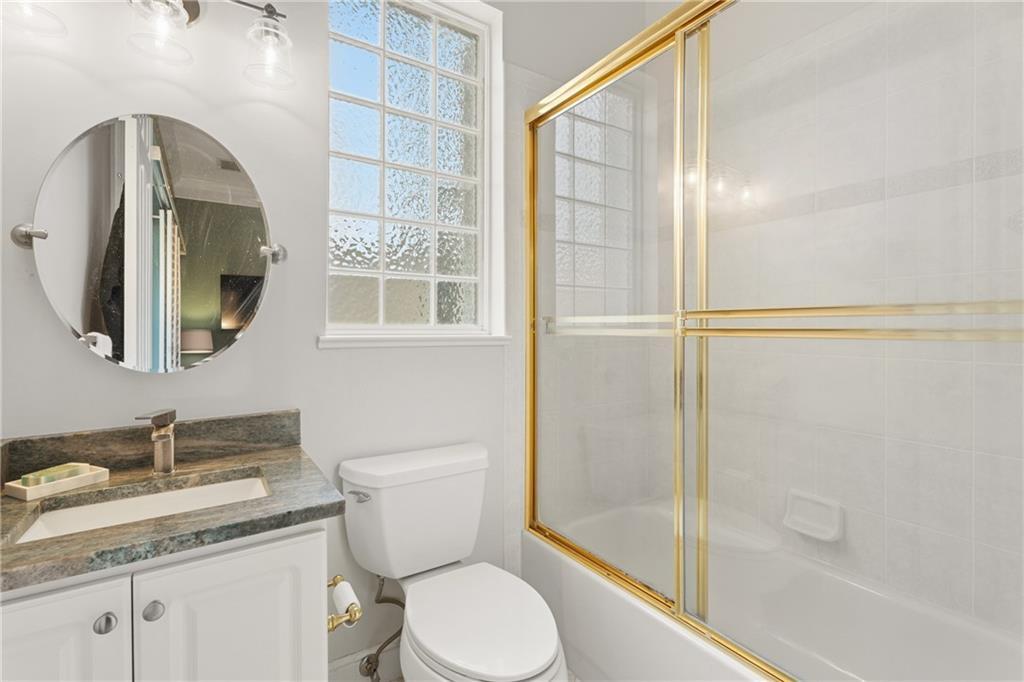 1344 Riverside Lane Vero Beach, FL 32963 - Photo 19 of 36 a bathroom with a granite countertop sink toilet and shower