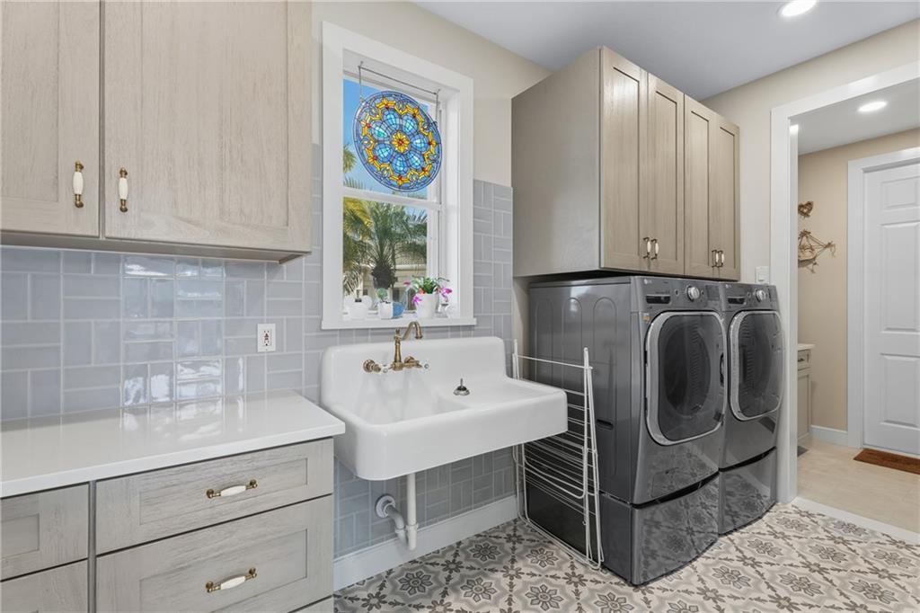 1344 Riverside Lane Vero Beach, FL 32963 - Photo 20 of 36 a utility room with cabinets washer and dryer