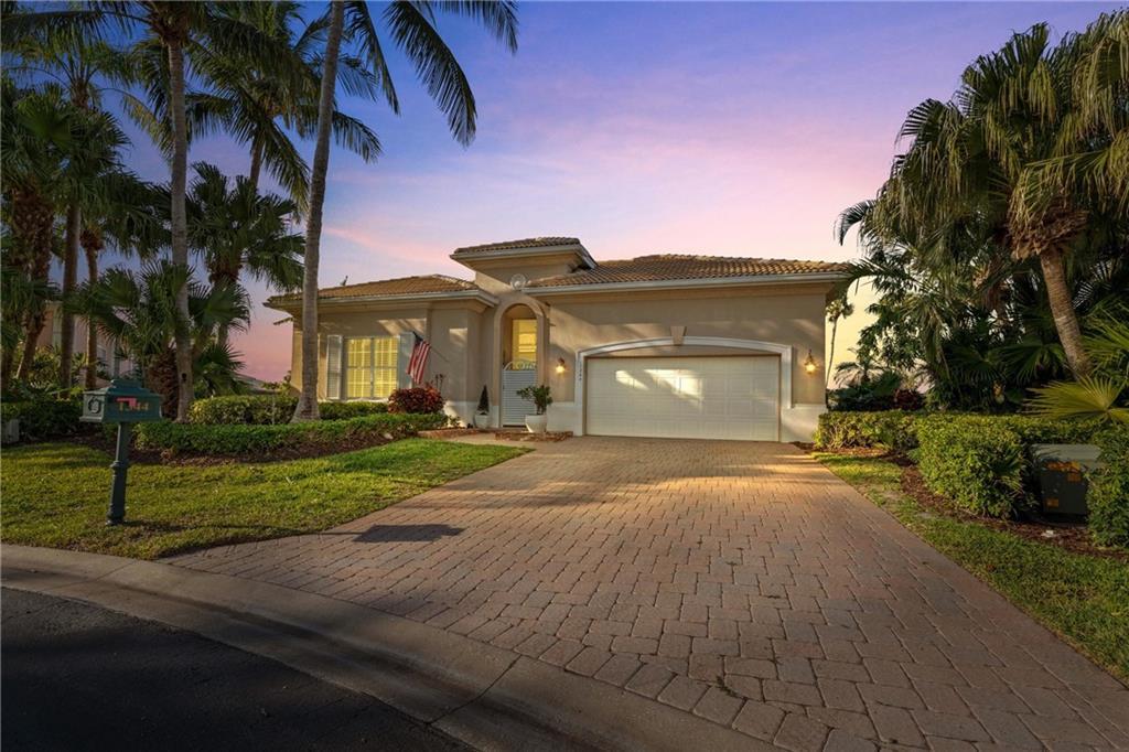 1344 Riverside Lane Vero Beach, FL 32963 - Photo 28 of 36 a front view of a house with a yard and garage