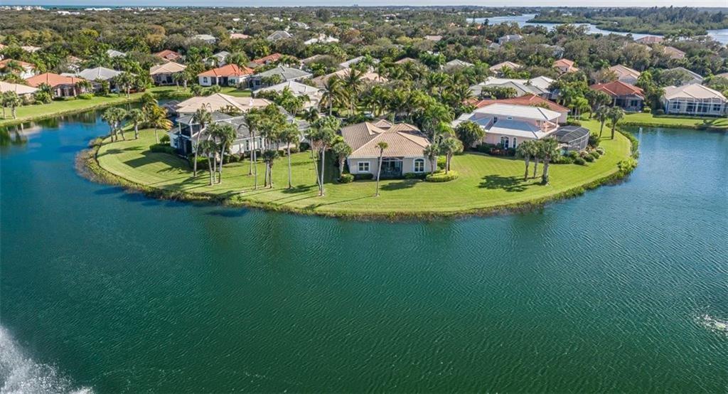 1344 Riverside Lane Vero Beach, FL 32963 - Photo 5 of 36 an aerial view of a house with a swimming pool yard and mountain view in back