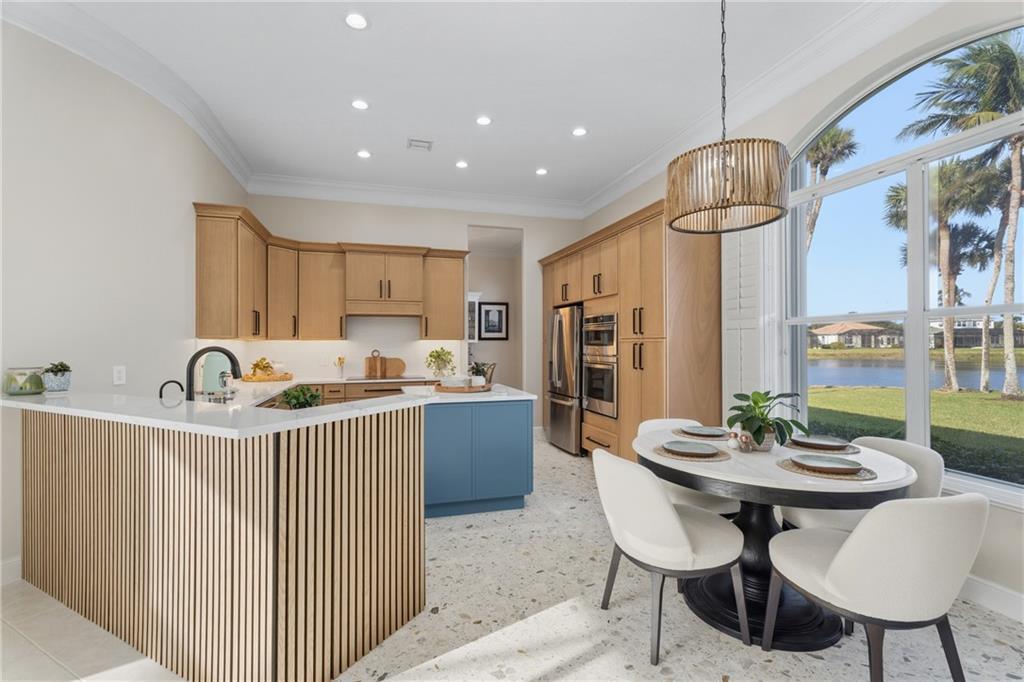 1344 Riverside Lane Vero Beach, FL 32963 - Photo 7 of 36 a kitchen that has a table and chairs in it