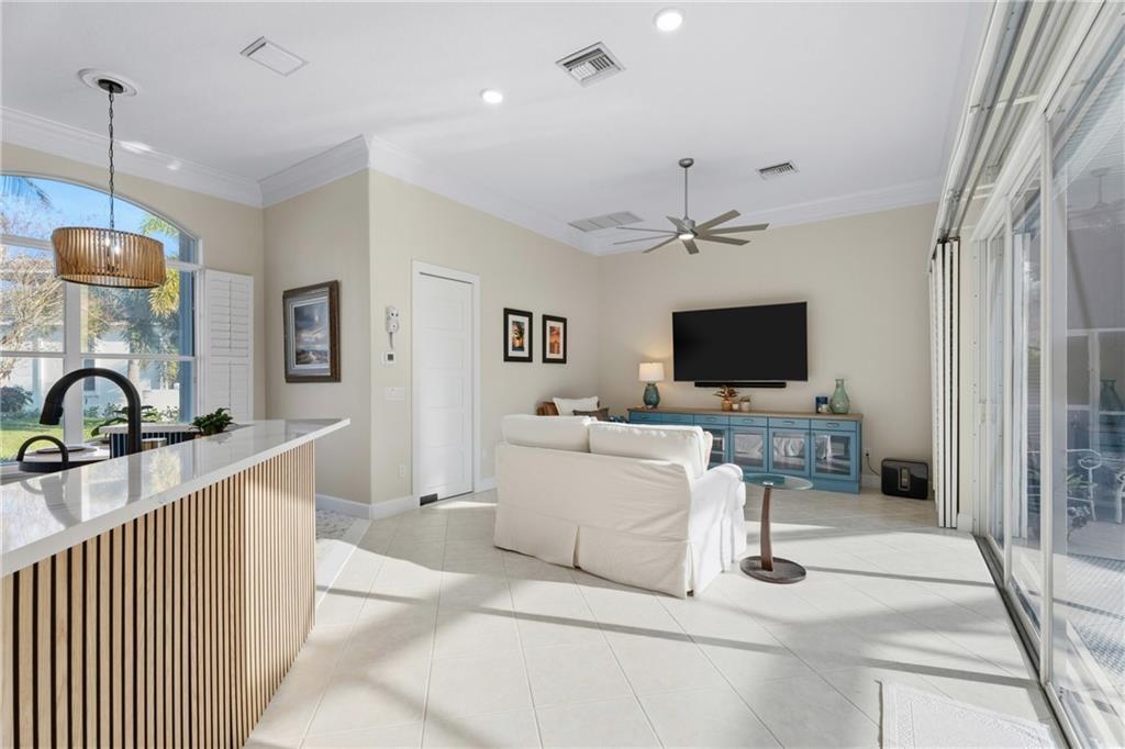 1344 Riverside Lane Vero Beach, FL 32963 - Photo 8 of 36 a living room with furniture and a flat screen tv