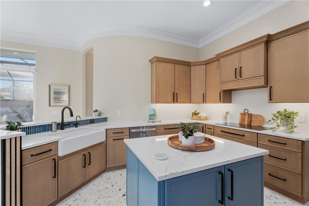 1344 Riverside Lane Vero Beach, FL 32963 - Photo 9 of 36 a kitchen with a sink dishwasher a stove and white countertops with wooden floor
