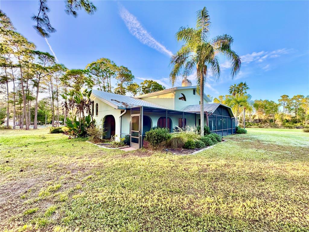 6068 Tidwell Street North Port, FL 34291 - Photo 17 of 92 a view of a house with a yard