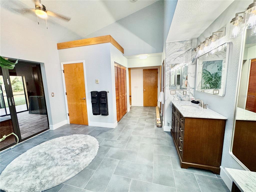 6068 Tidwell Street North Port, FL 34291 - Photo 55 of 92 a large bathroom with a sink and a mirror