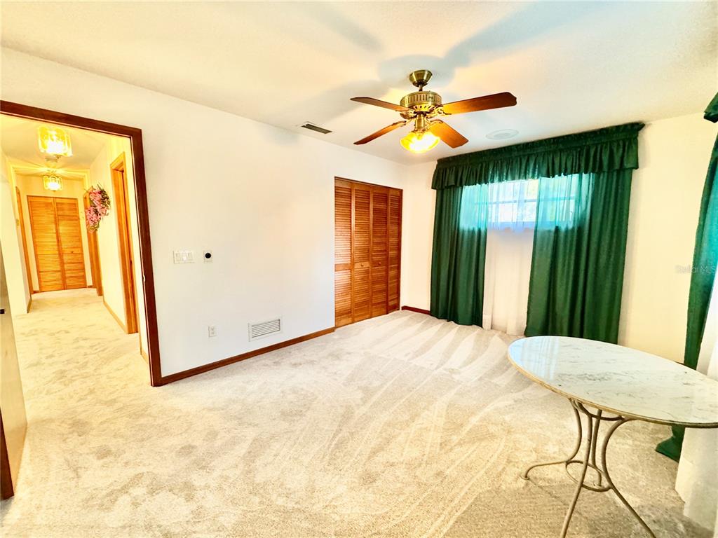 6068 Tidwell Street North Port, FL 34291 - Photo 61 of 92 a bedroom with a bed and a chandelier