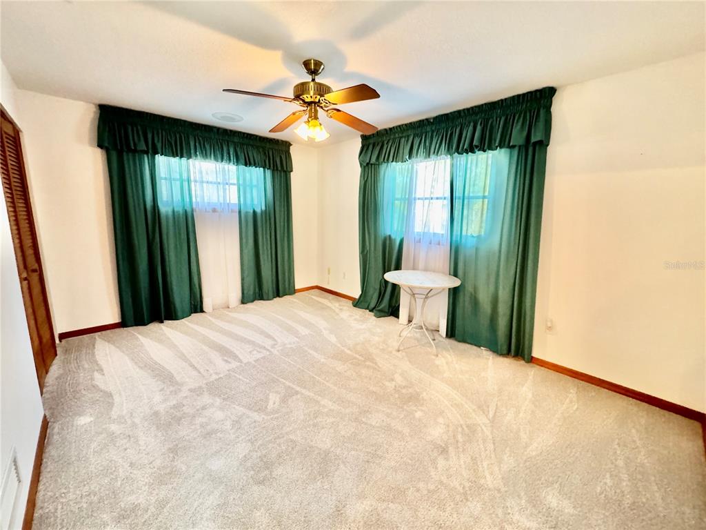 6068 Tidwell Street North Port, FL 34291 - Photo 62 of 92 a bedroom with a large bed and a large window