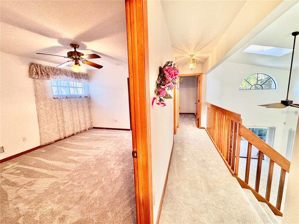 6068 Tidwell Street North Port, FL 34291 - Photo 65 of 92 a view of a hallway with a chandelier