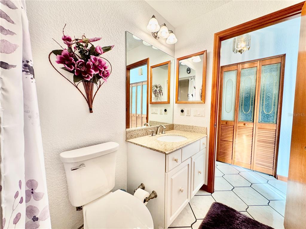 6068 Tidwell Street North Port, FL 34291 - Photo 73 of 92 a bathroom with a granite countertop sink mirror vanity and toilet