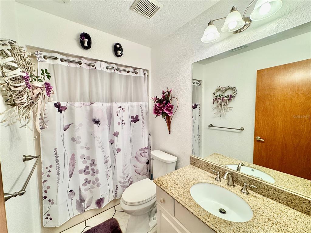 6068 Tidwell Street North Port, FL 34291 - Photo 74 of 92 a bathroom with a sink vanity mirror and toilet