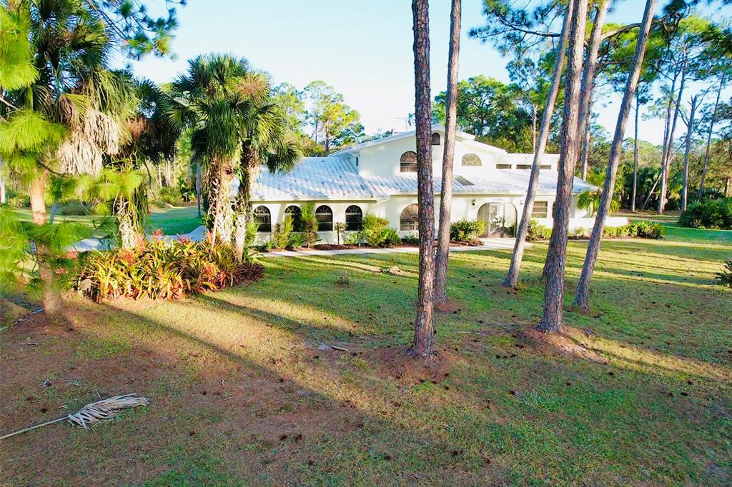 6068 Tidwell Street North Port, FL 34291 - Photo 80 of 92 a view of a park with swings and slides