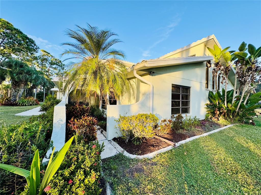 6068 Tidwell Street North Port, FL 34291 - Photo 86 of 92 a view of a house with a yard and potted plants