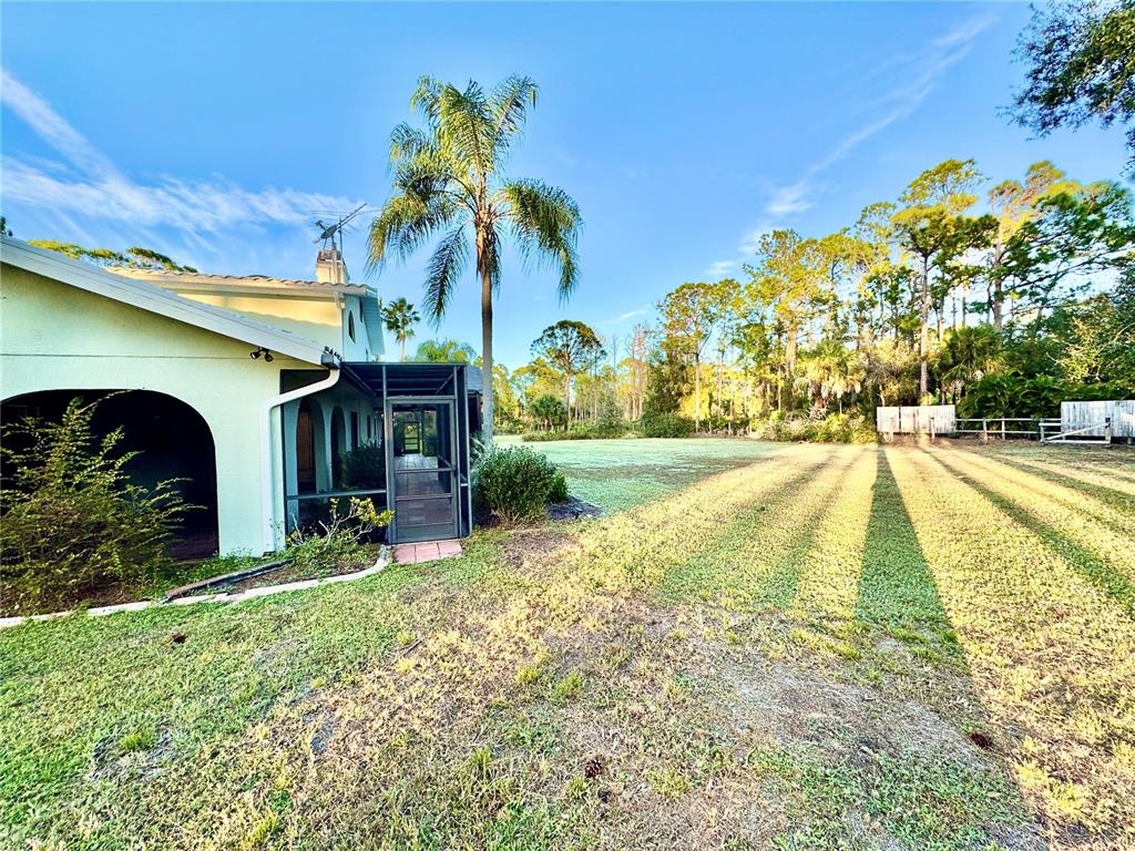 6068 Tidwell Street North Port, FL 34291 - Photo 92 of 92 a view of backyard with swimming pool and outdoor seating