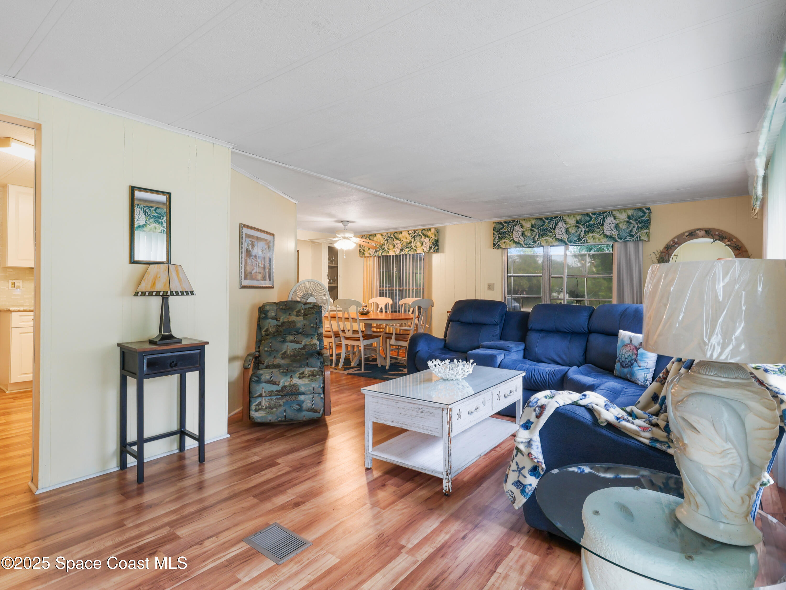 585 Canaveral Groves Boulevard Cocoa, FL 32926 - Photo 11 of 49 a living room with furniture and wooden floor