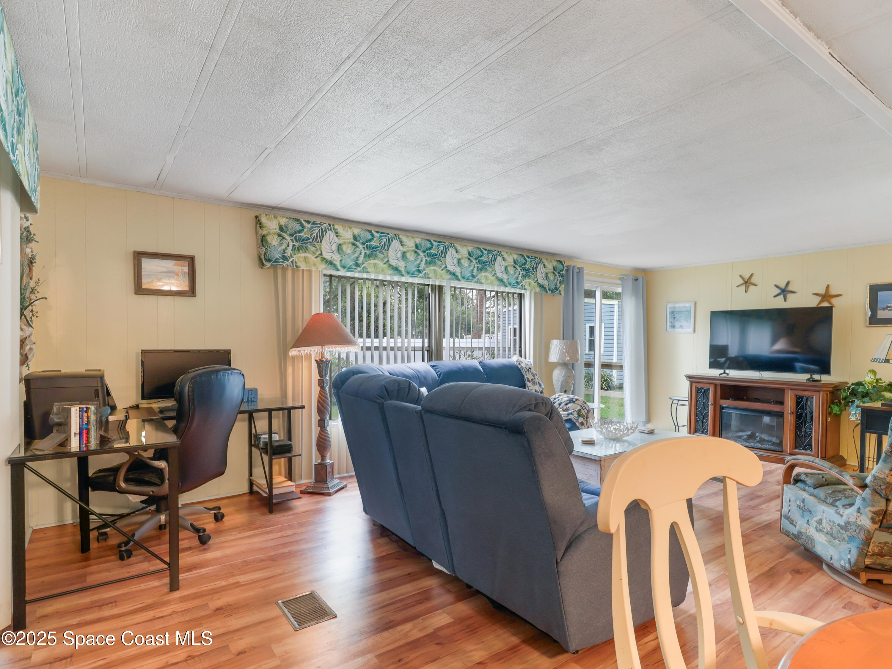 585 Canaveral Groves Boulevard Cocoa, FL 32926 - Photo 12 of 49 a living room with furniture and a flat screen tv
