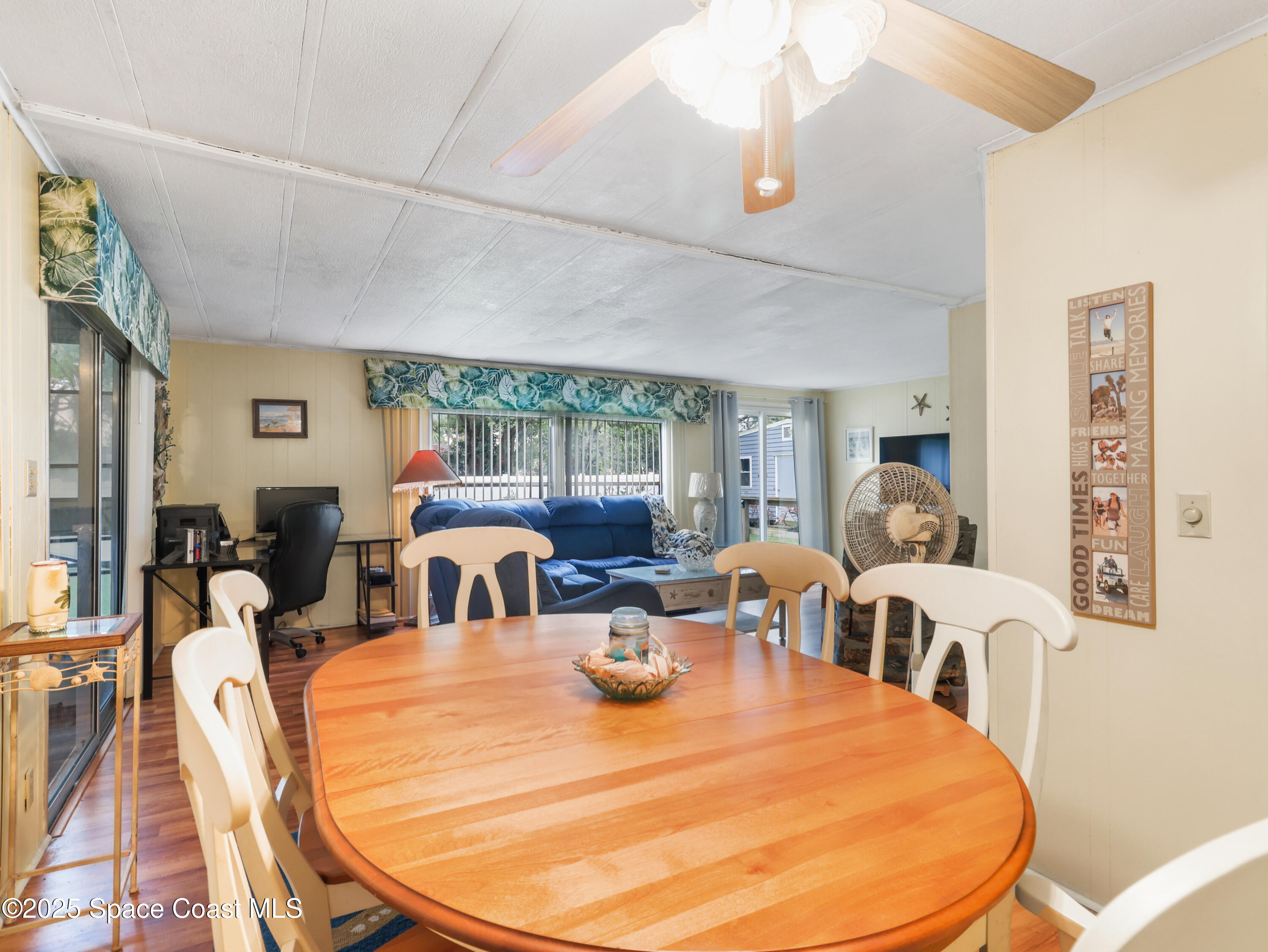 585 Canaveral Groves Boulevard Cocoa, FL 32926 - Photo 13 of 49 a dining room with furniture and wooden floor