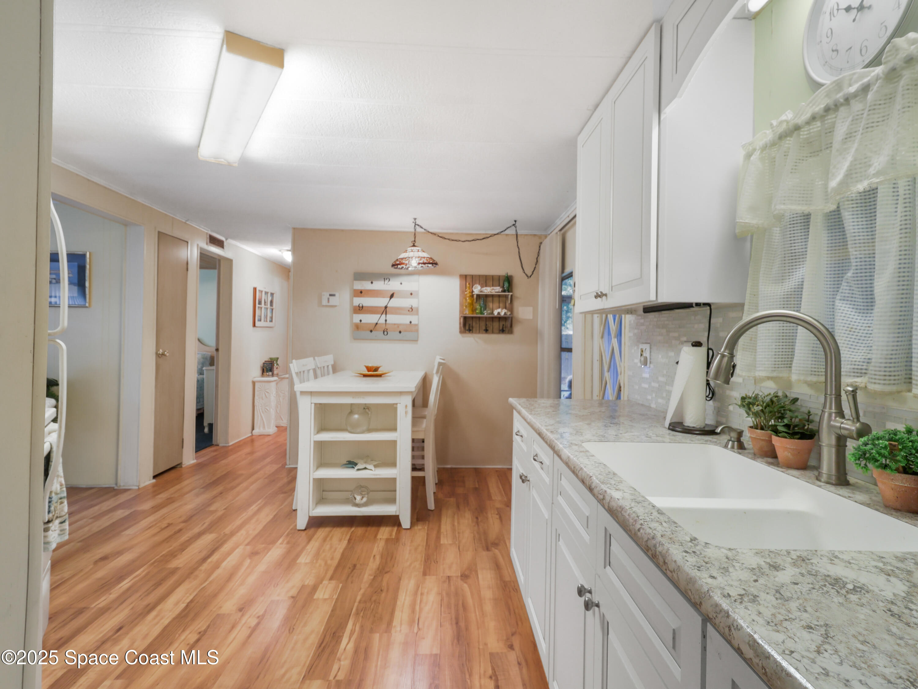 585 Canaveral Groves Boulevard Cocoa, FL 32926 - Photo 15 of 49 a kitchen with stainless steel appliances granite countertop a sink stove and refrigerator