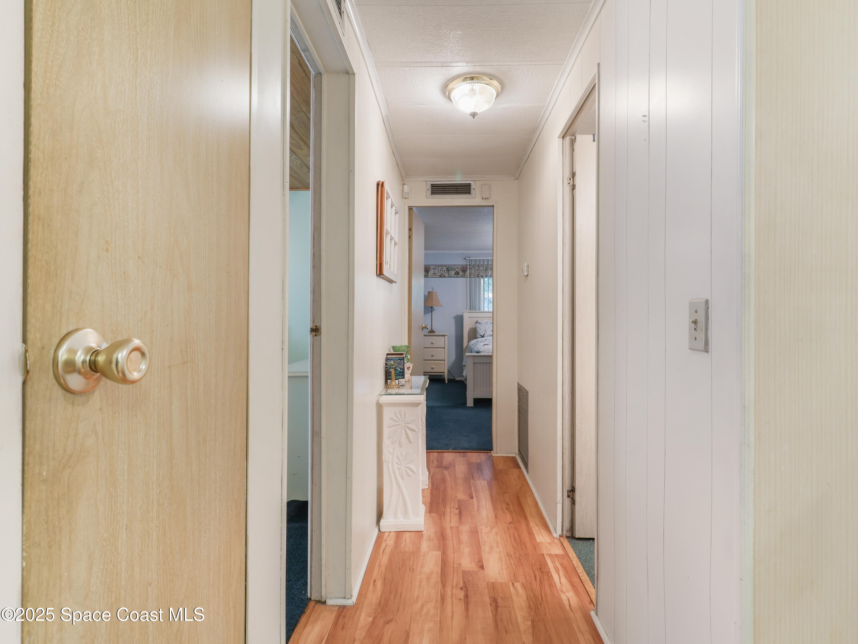 585 Canaveral Groves Boulevard Cocoa, FL 32926 - Photo 16 of 49 a view of a hallway with wooden floor