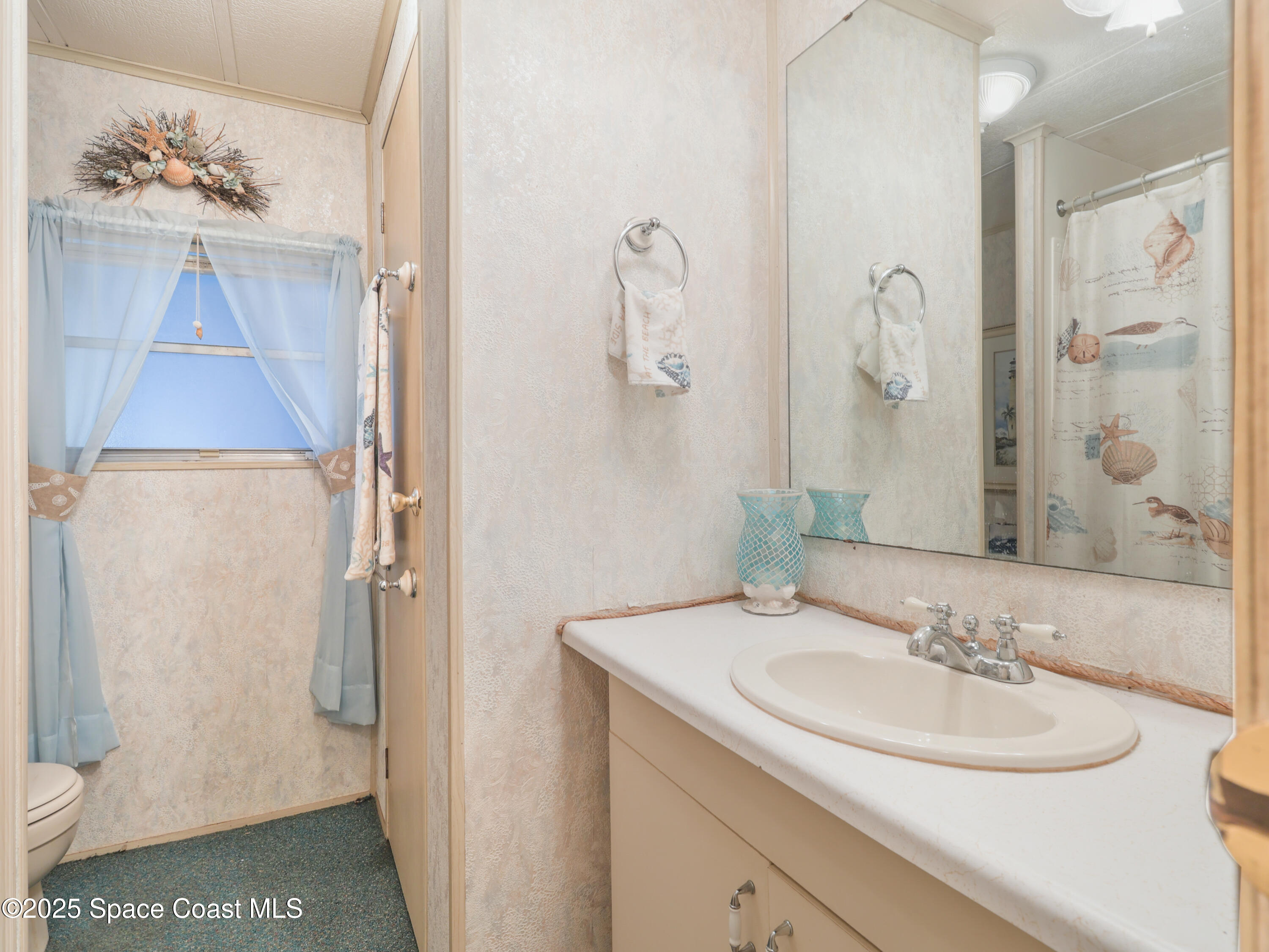 585 Canaveral Groves Boulevard Cocoa, FL 32926 - Photo 17 of 49 a bathroom with a sink and a mirror