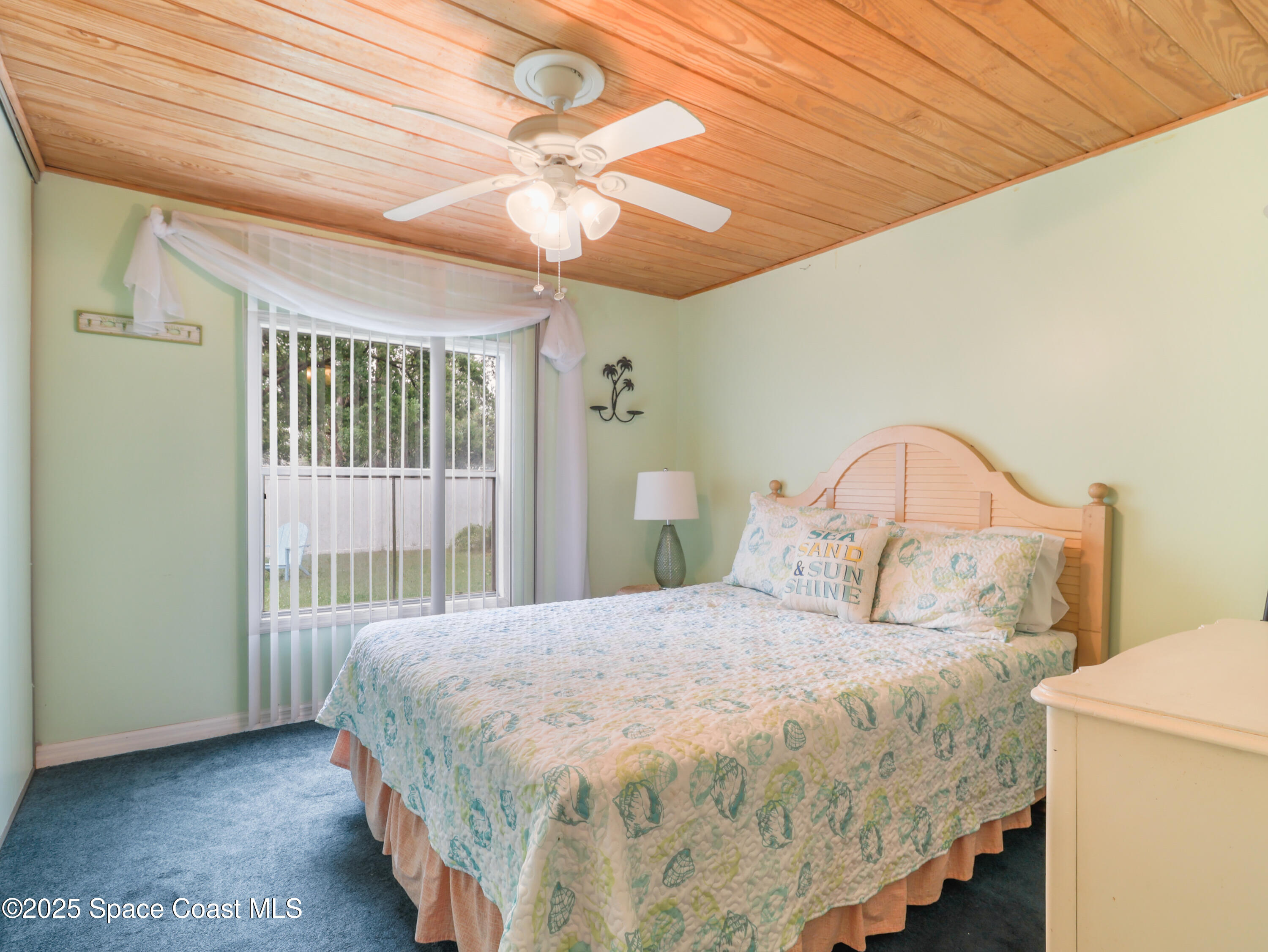 585 Canaveral Groves Boulevard Cocoa, FL 32926 - Photo 18 of 49 a bedroom with a bed and a window