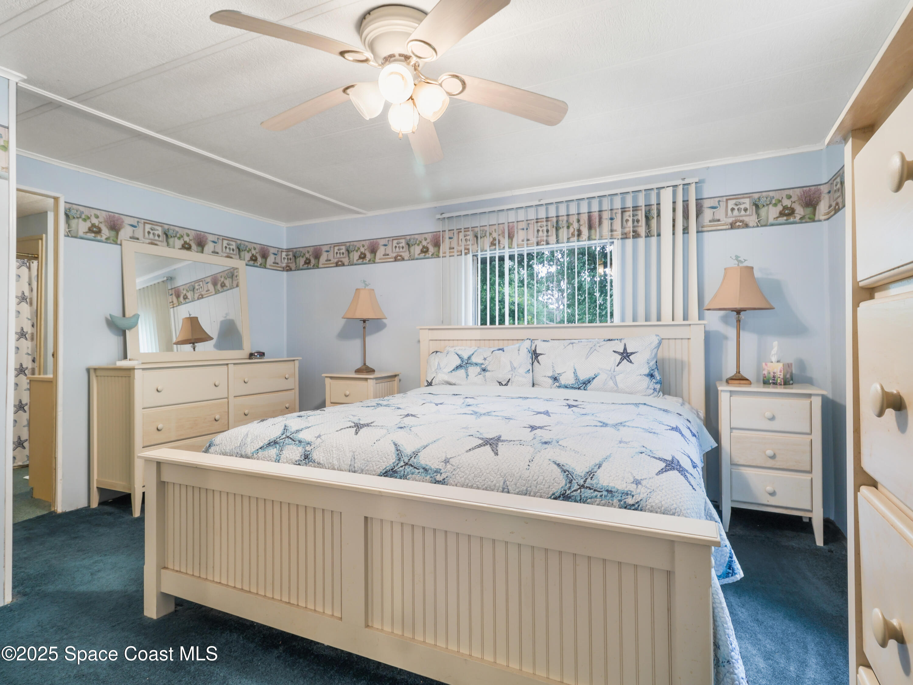 585 Canaveral Groves Boulevard Cocoa, FL 32926 - Photo 20 of 49 a bedroom with a bed a window and dresser