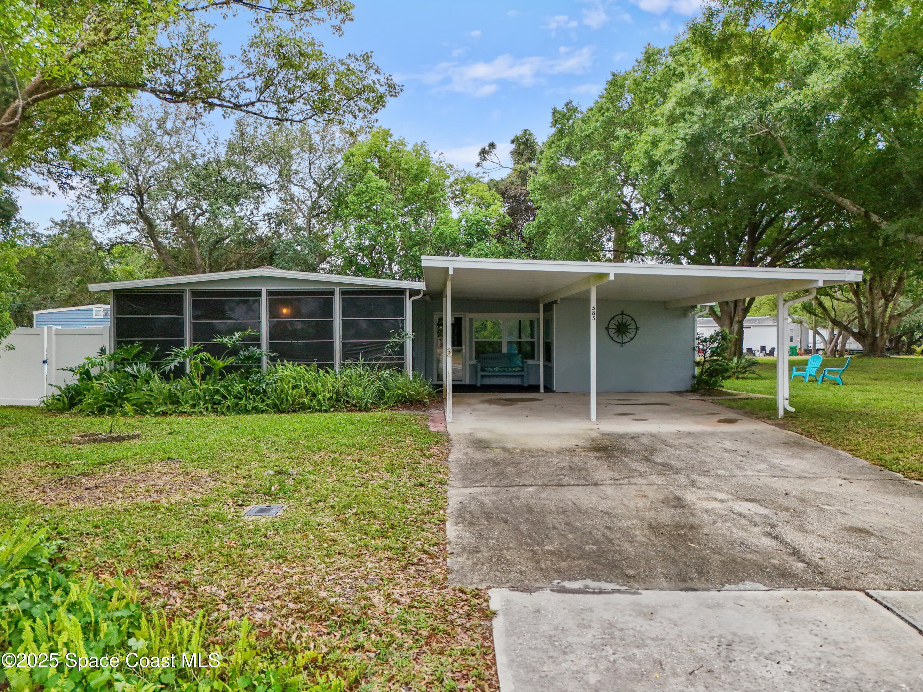 585 Canaveral Groves Boulevard Cocoa, FL 32926 - Photo 2 of 49 front view of a house with a yard