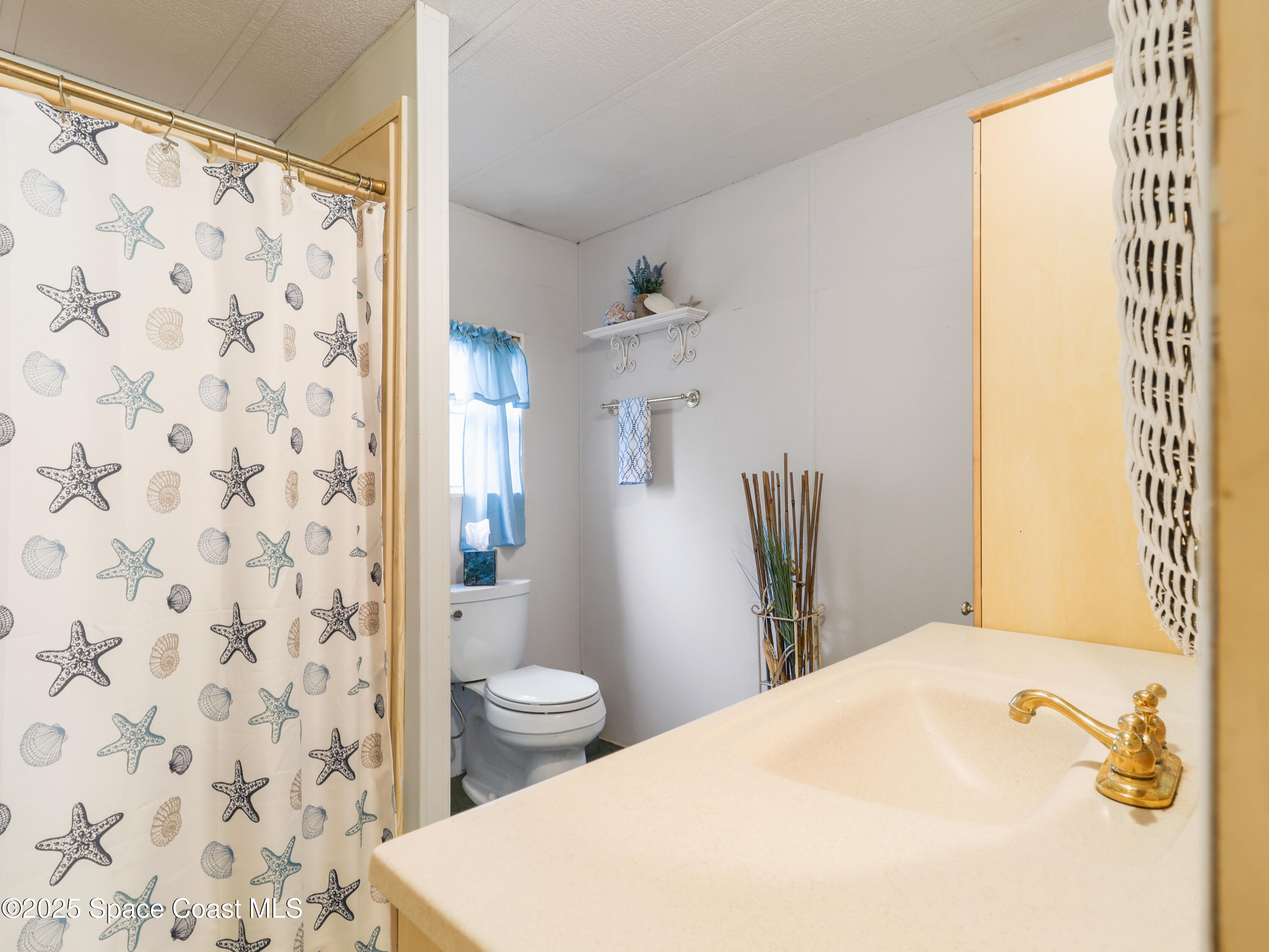 585 Canaveral Groves Boulevard Cocoa, FL 32926 - Photo 21 of 49 a bathroom with a sink and a toilet