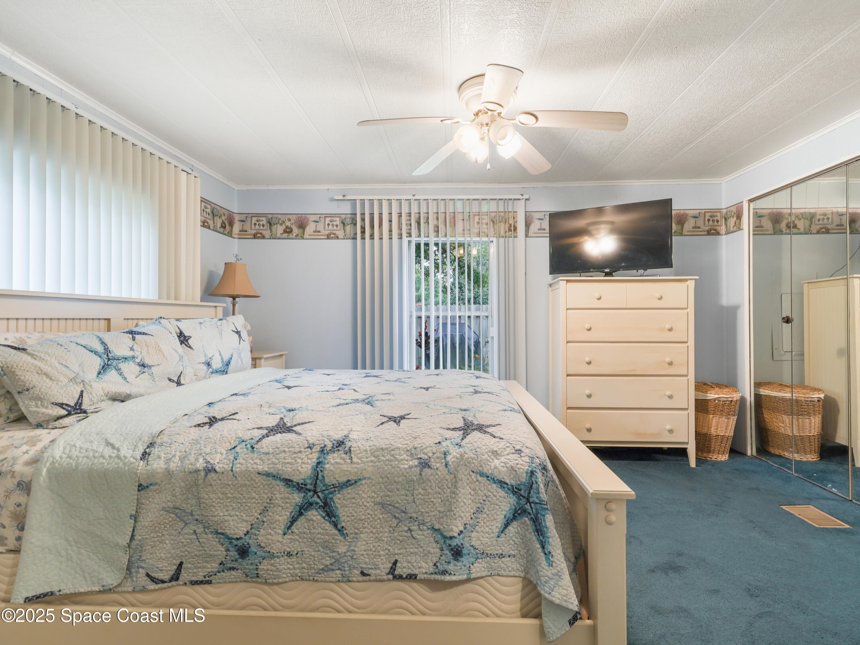585 Canaveral Groves Boulevard Cocoa, FL 32926 - Photo 23 of 49 a bedroom with a bed and a mirror